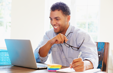 photo: a man on a laptop