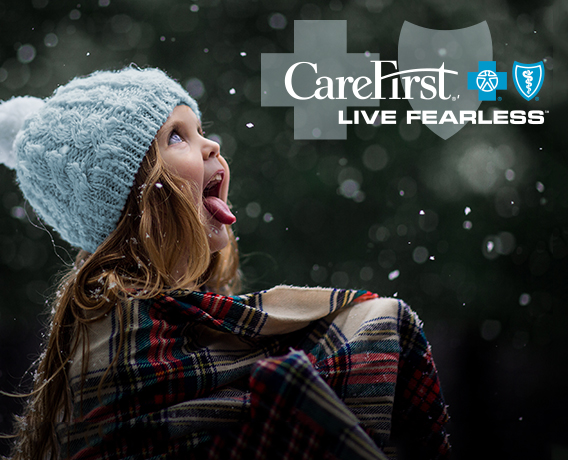 Little girl catching snowflakes