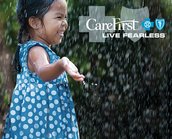 Little girl splashing in the rain