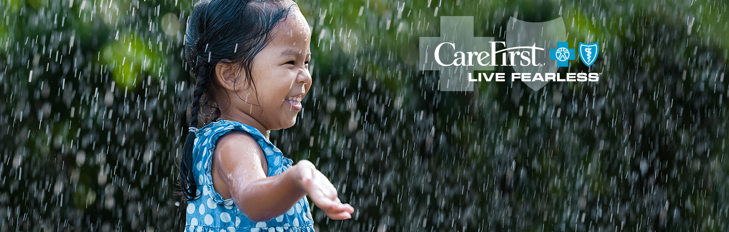 Little girl splashing in the rain