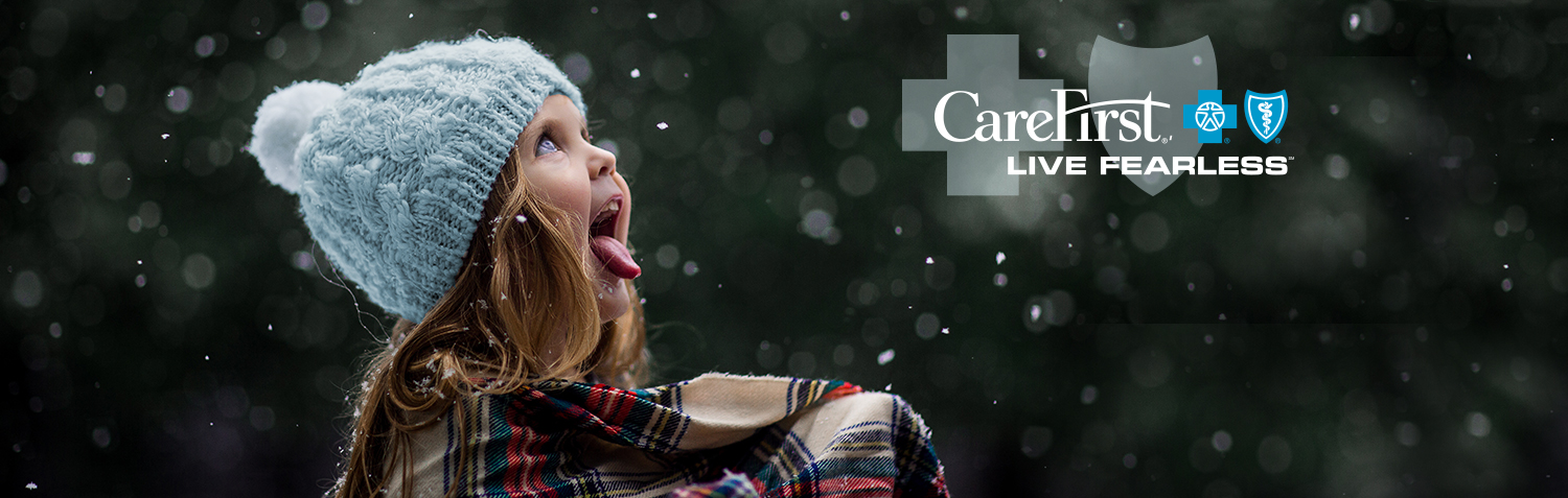 Little girl catching snowflakes