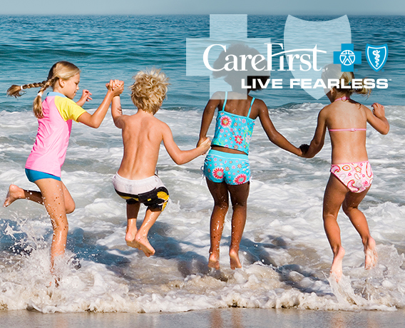 Young children splashing in the beach waves