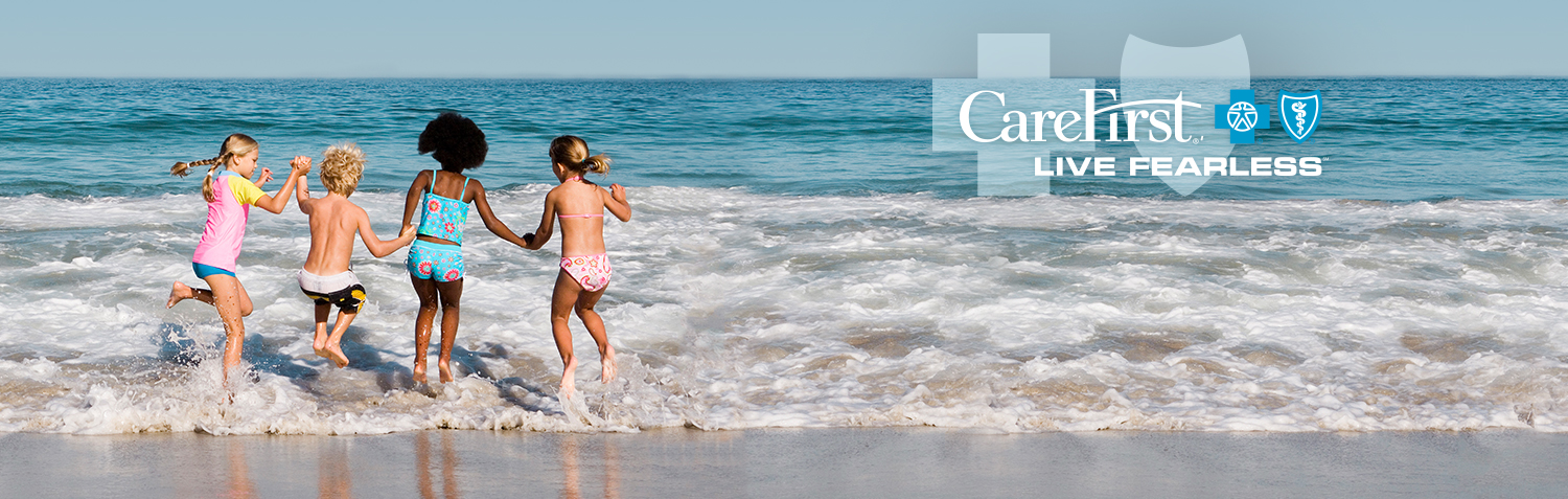 Young children splashing in the beach waves