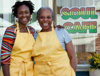 Mother and daughter outside cafe