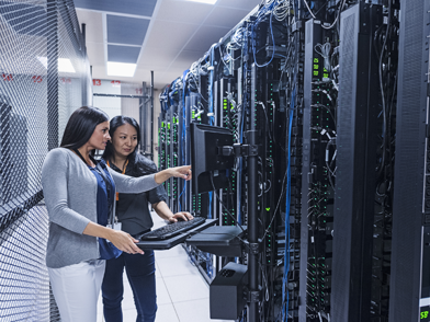 Female Cloud Architects inspecting a server room