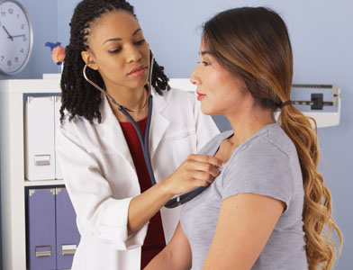 doctor listening to patient's lungs