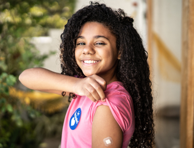 girl with vaccine bandaid