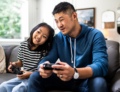 father and daughter playing video game