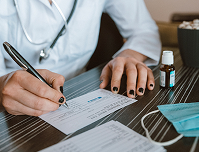 pharmacist filling out a vaccine card