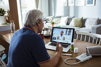older man having virtual doctor visit